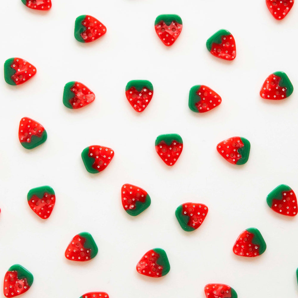 Pattern of red and green strawberry-shaped strawberries on a white background