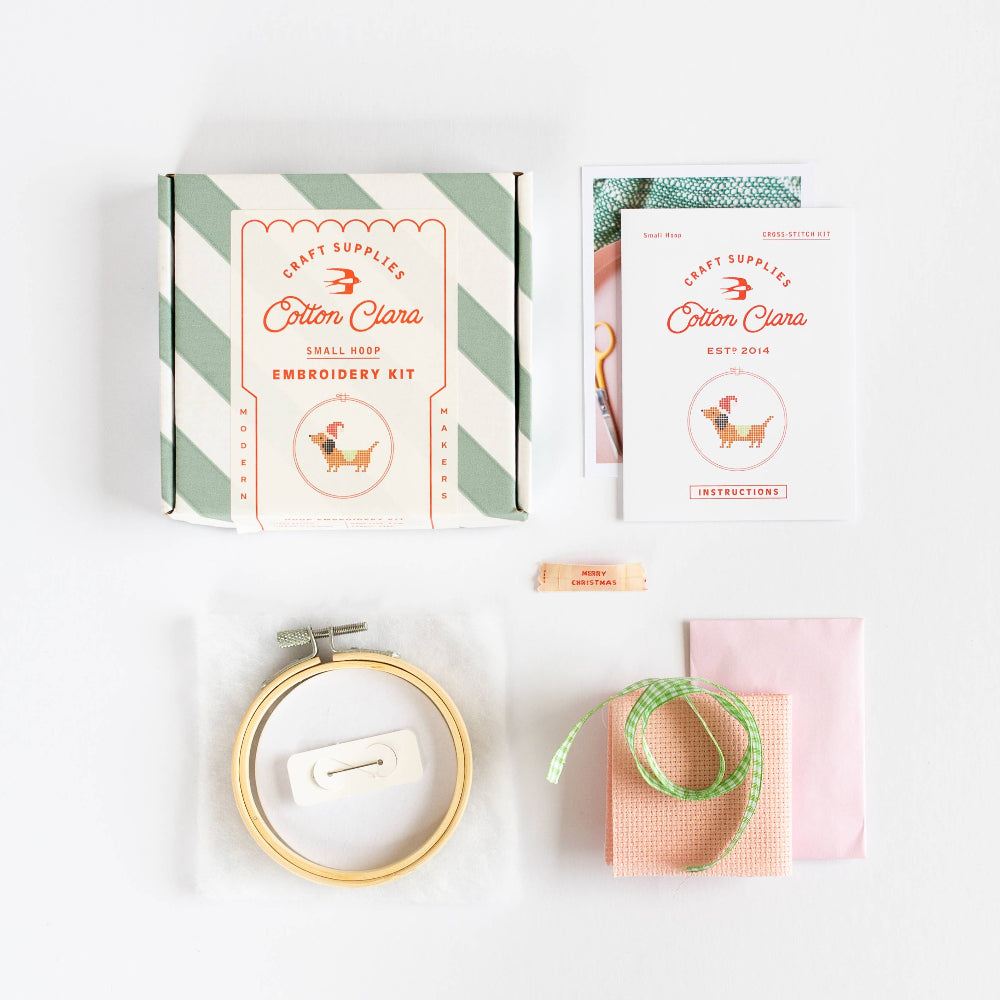 Embroidery kit with hoop, thread, and packaging on a white background
