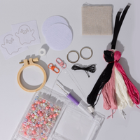 punch needle DIY kit with a hoop, beads, host template, and keychain notions.