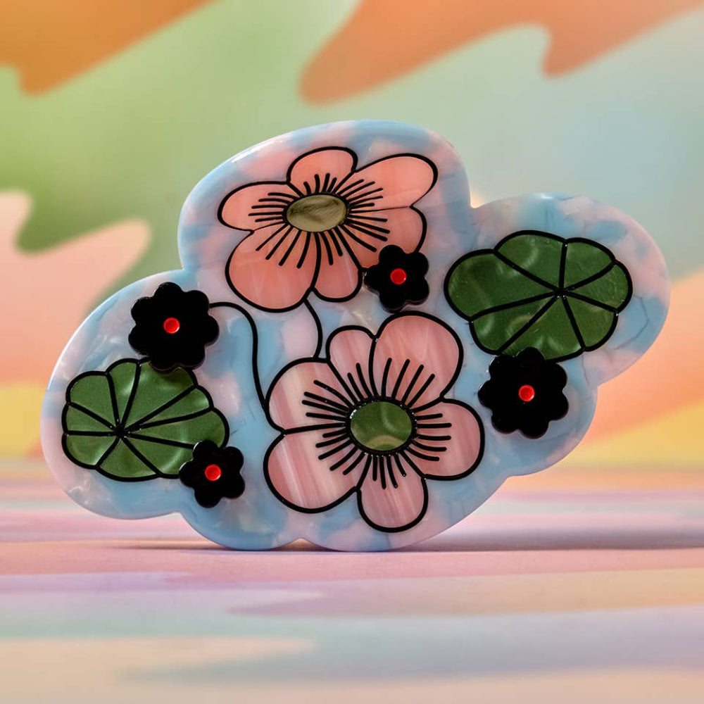 Decorative cloud-shaped object with floral designs on a colorful background