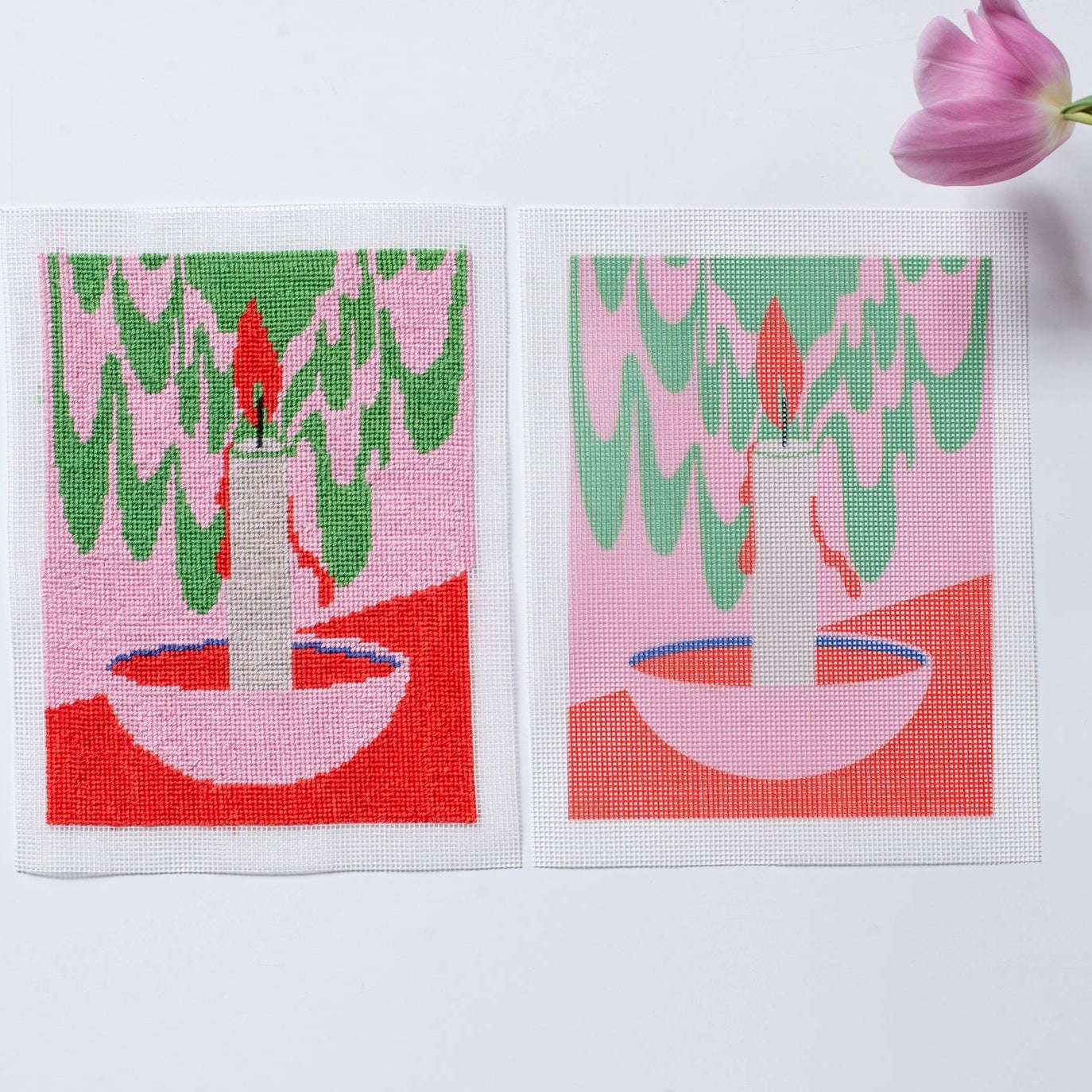 Two needlepoint canvases with a candle design on a white background with tulips.