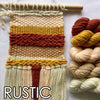 Woven wall art with rustic colors and skeins of yarn on a white background