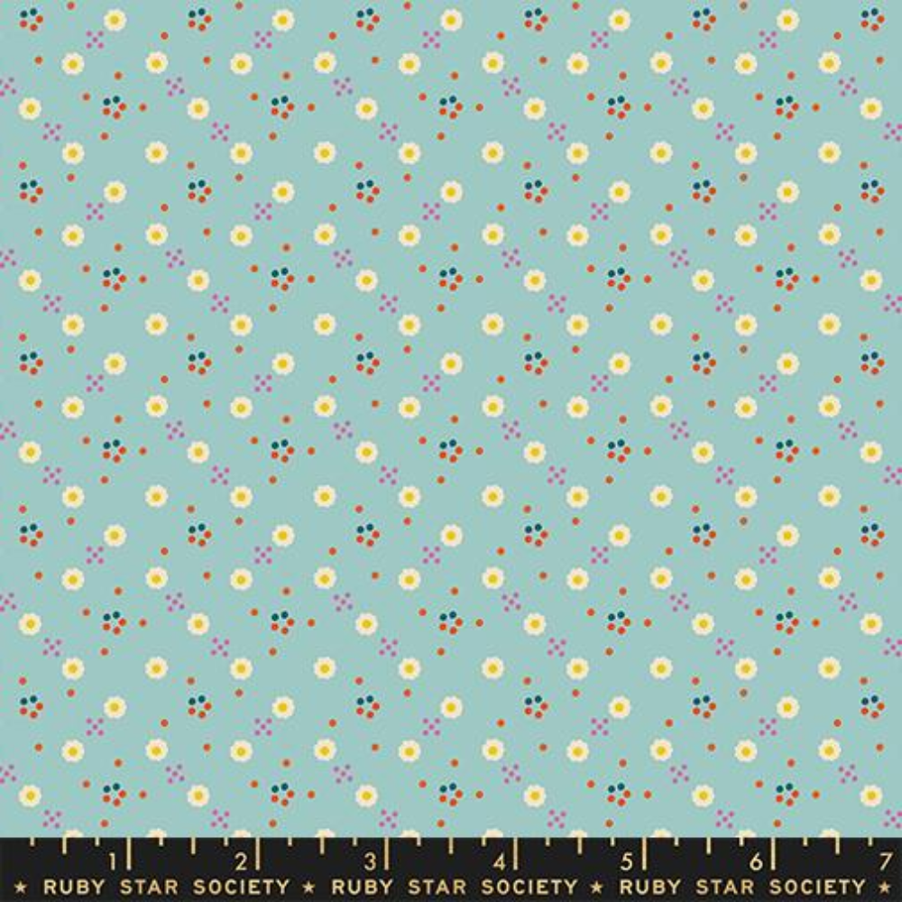 White daisies spread across a light blue background with little orange and pink dots surrounding.