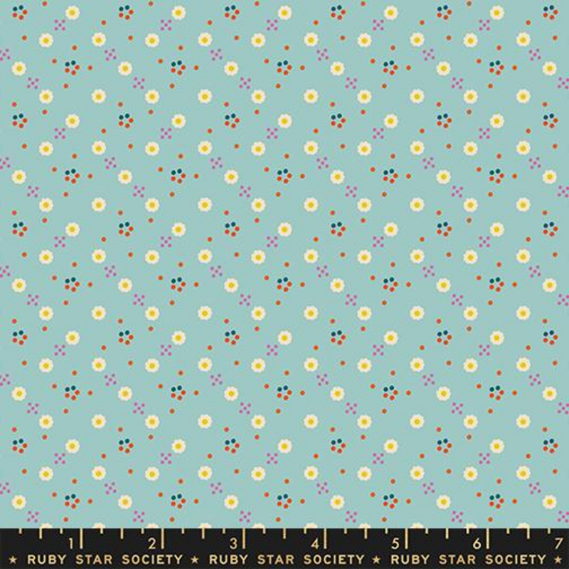 White daisies spread across a light blue background with little orange and pink dots surrounding.