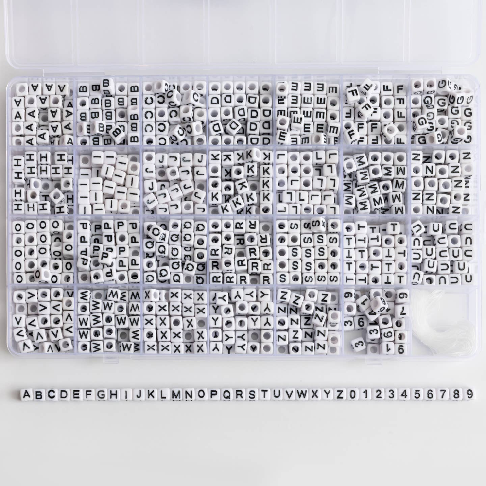 divided box with different black and white letter beads in each section