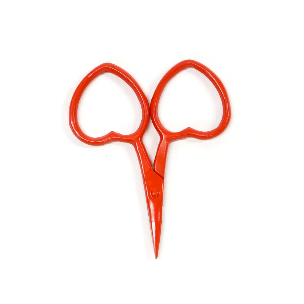 Red scissors with heart-shaped handles on a white background