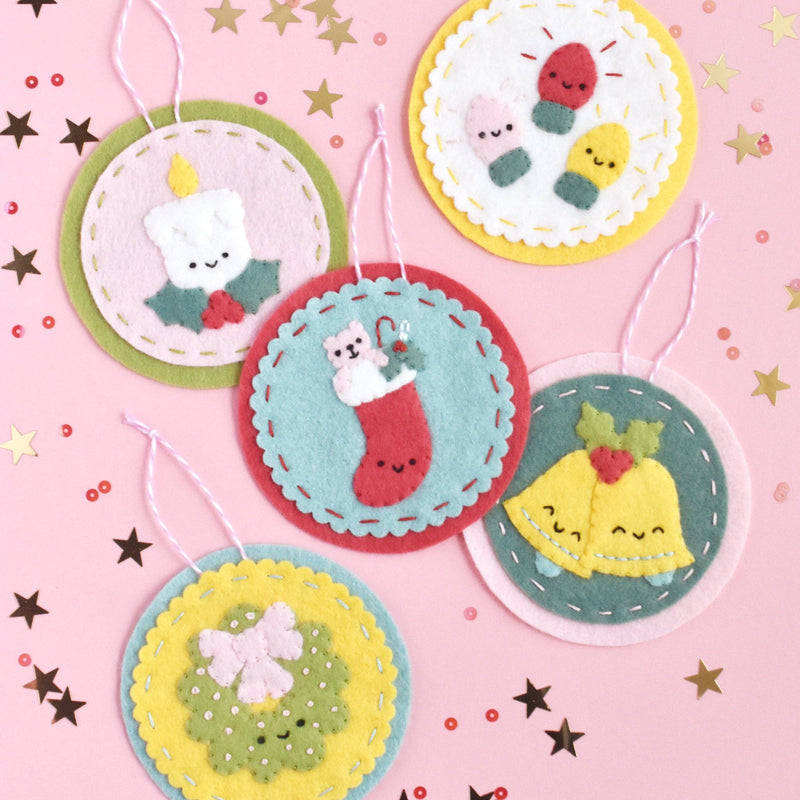 Various felt ornaments on a light pink background with star and sequin congetti