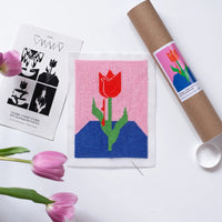 Needlepoint kit with red tulip on pink and blue background