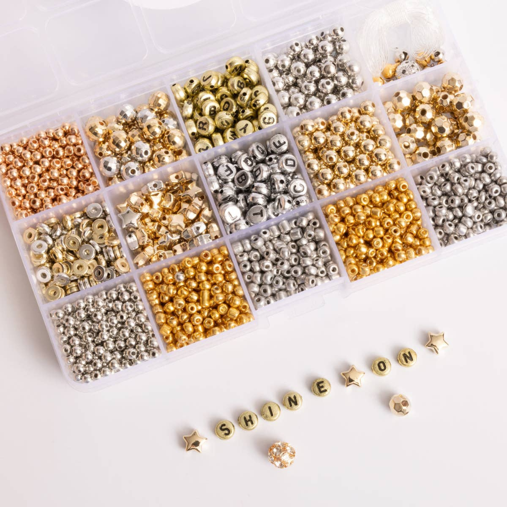 divided box with different metallic beads in each compartment. In the front gold beads spell out "shine on."