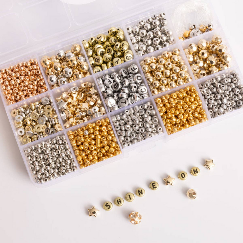 divided box with different metallic beads in each compartment. In the front gold beads spell out "shine on."