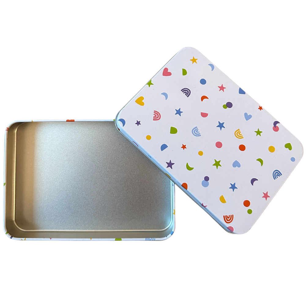 Metallic tin with a colorful patterned lid on a white background