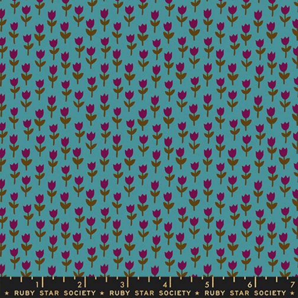 Purple-red tulips on green stems across a bright blue background.