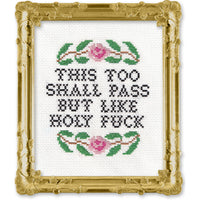 Cross-stitched design with text and floral patterns in a decorative gold frame.