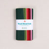 Multicolor felt sheets in greens, reds, and pinks in a "Wool Blend Felt" label on a textured white background