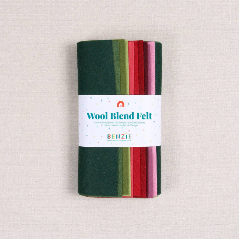 Multicolor felt sheets in greens, reds, and pinks in a "Wool Blend Felt" label on a textured white background