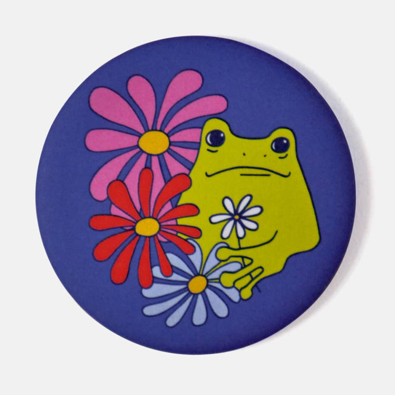 magnet with a green frog and colorful flowers on a blue background