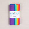 Multicolor felt sheets in a bright rainbow of shades in a "Wool Blend Felt" label on a textured white background