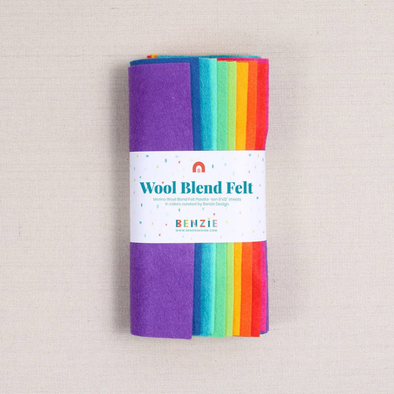 Multicolor felt sheets in a bright rainbow of shades in a "Wool Blend Felt" label on a textured white background