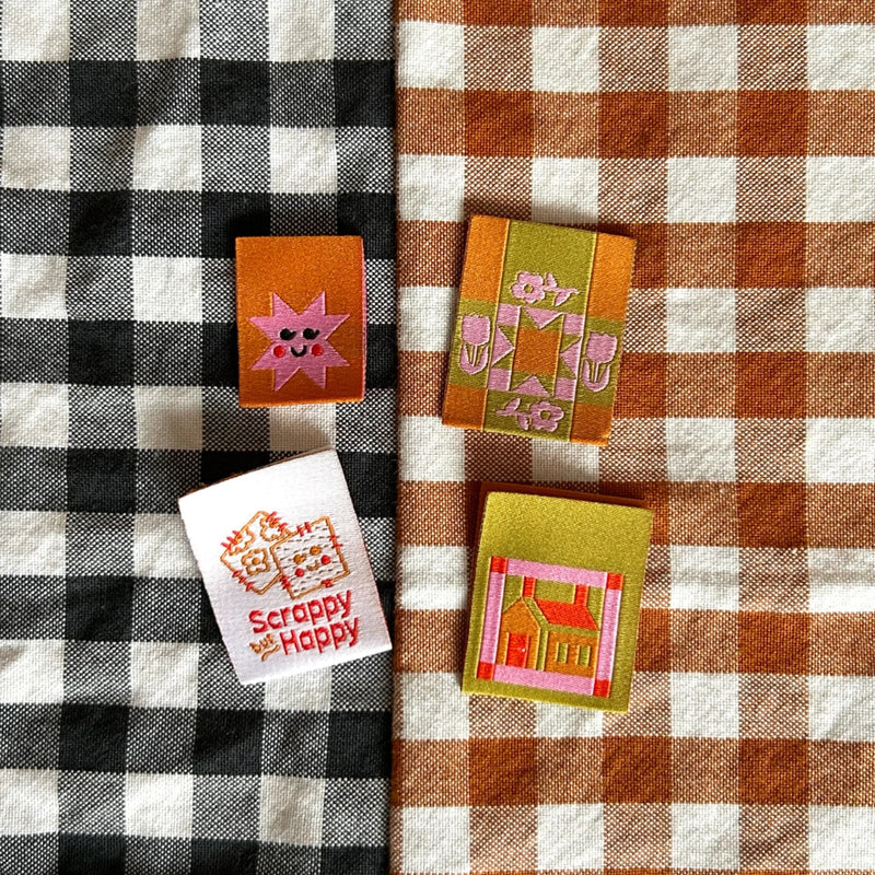 Four fabric patches on a checkered tablecloth with 'Scrappy Happy' label.