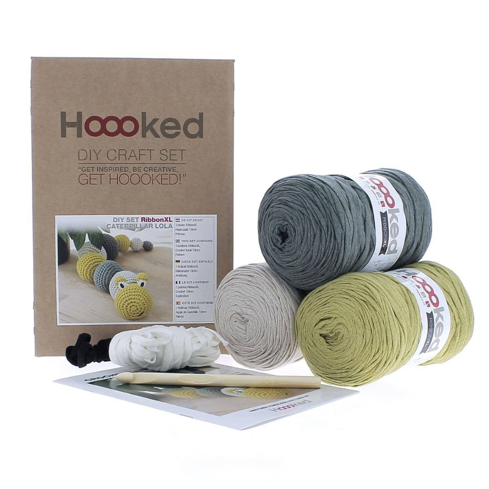 Crochet kit packaging with green, gray and yellow yarn