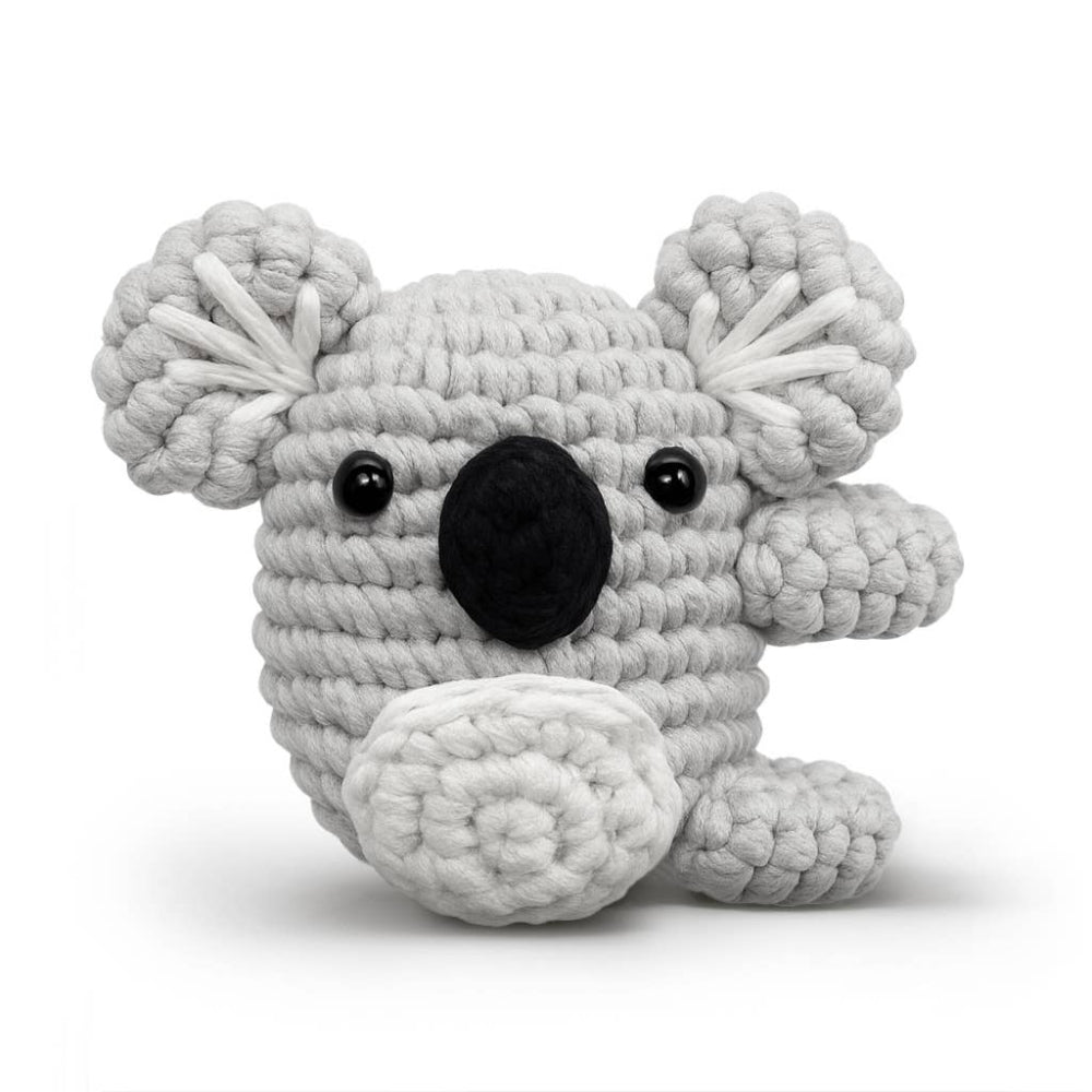 Crocheted koala toy on a white background