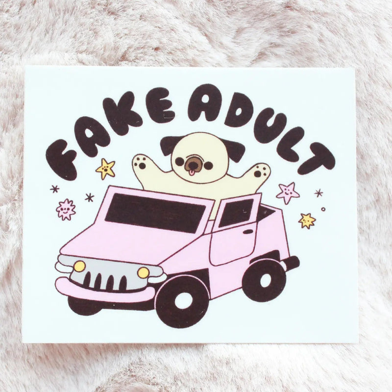 Dog sitting in a pink car with the words "Fake Adult" on top of it, on a background of beige fur