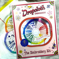 Embroidery kit with colorful design on a white fabric background