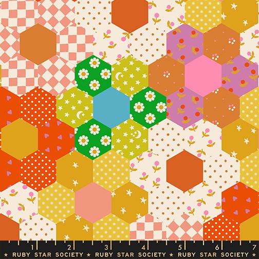 Hexagonal pattern fabric with colorful shapes and patterns on a white background