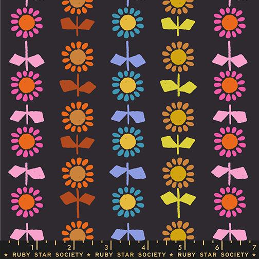 Colorful floral pattern on a black background with a ruler at the bottom.