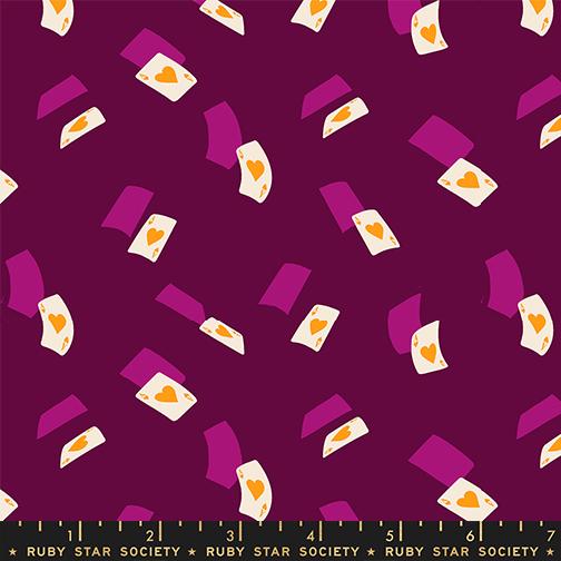 Pattern of white and yellow playing cards falling on a purple background with Ruby Star Society label