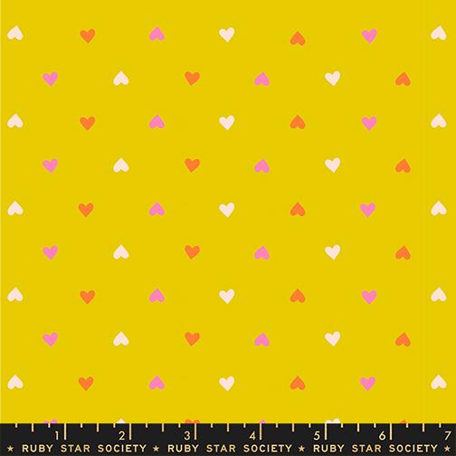 Pattern of small hearts on a yellow background with a ruler at the bottom.