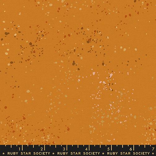 Fabric swatch with a speckled pattern on an orange background, featuring the Ruby Star Society label.