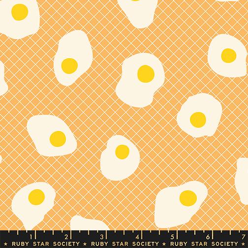 Pattern of white eggs with yellow yolks on a peach background, featuring Ruby Star Society label.