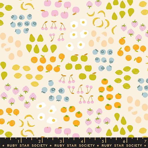 Patterned fabric with fruits and eggs on a beige background, featuring a ruler at the bottom.