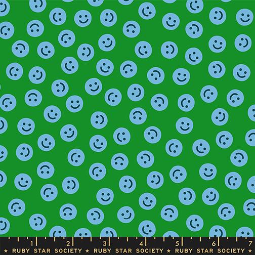 Pattern of blue smiley faces on a green background with Ruby Star Society label.