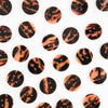 Pattern of tortoiseshell buttons on a white background