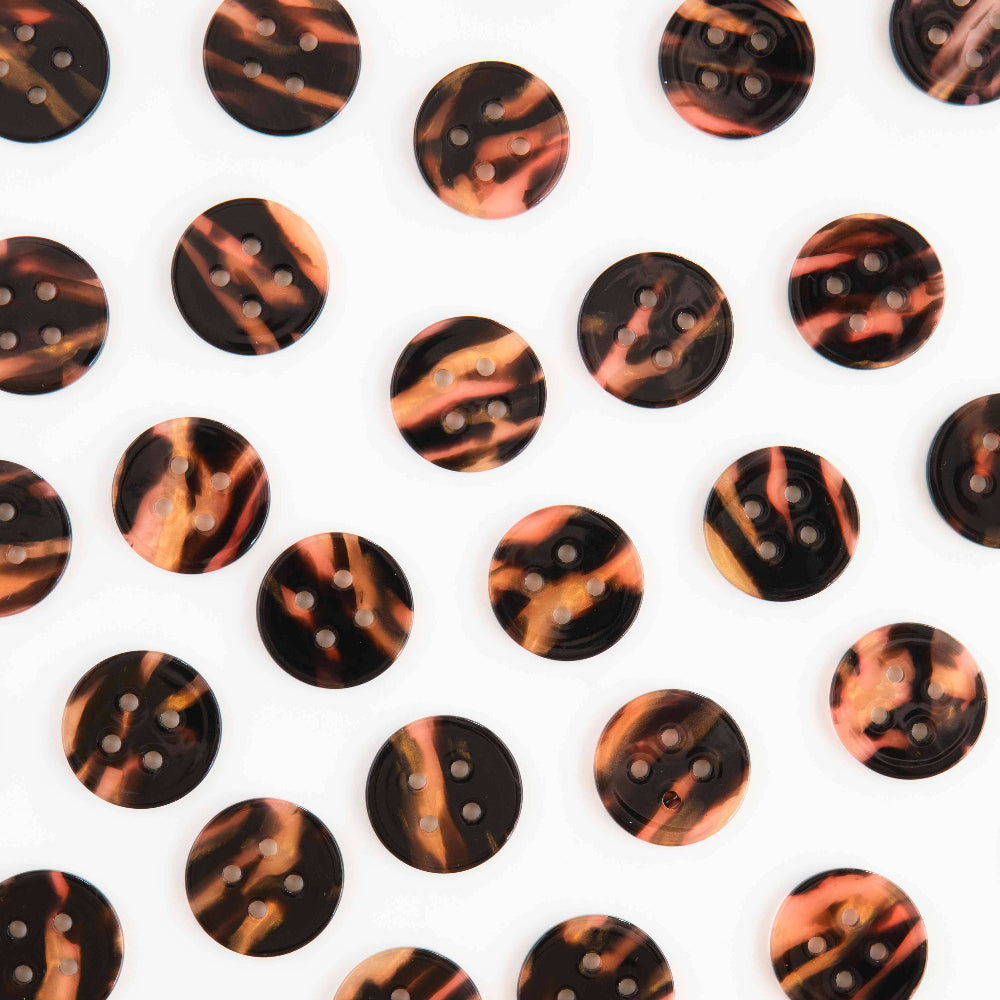 Pattern of tortoiseshell buttons on a white background