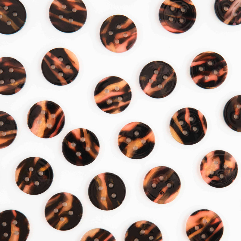 Pattern of tortoiseshell buttons on a white background