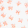 Pattern of pink bow shapes on a white background