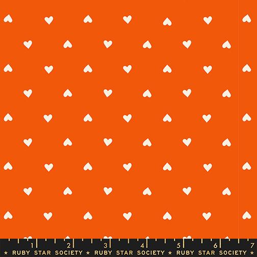 White heart shapes on an orange background with a Ruby Star Society label at the bottom.
