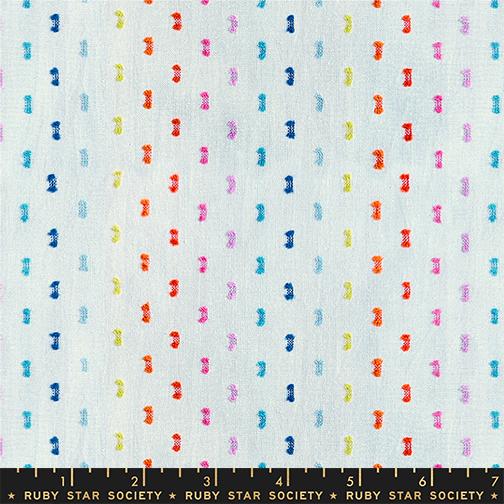 Patterned fabric with colorful small shapes on a light blue background, featuring the Ruby Star Society label.