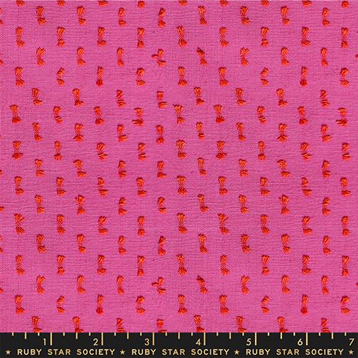 Fabric with red pattern on pink background, labeled Ruby Star Society