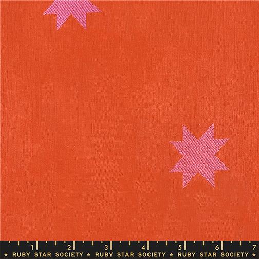 Fabric with pink stars on an orange background, featuring Ruby Star Society label.
