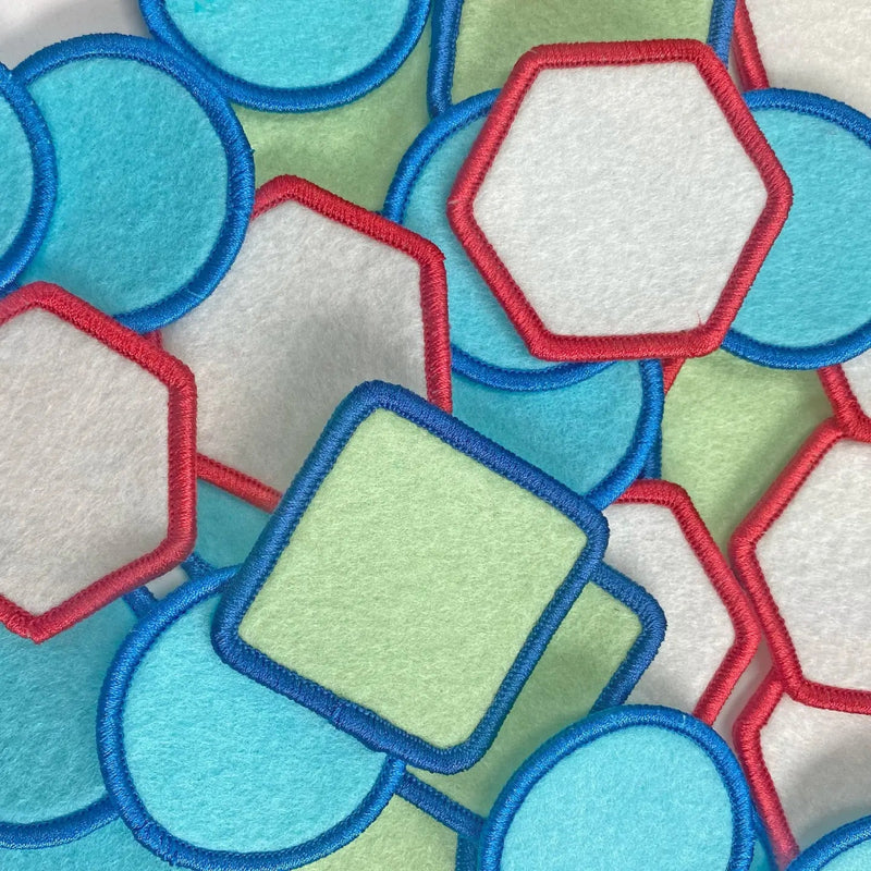 Close-up of colorful geometric patches with red, blue, and green borders.