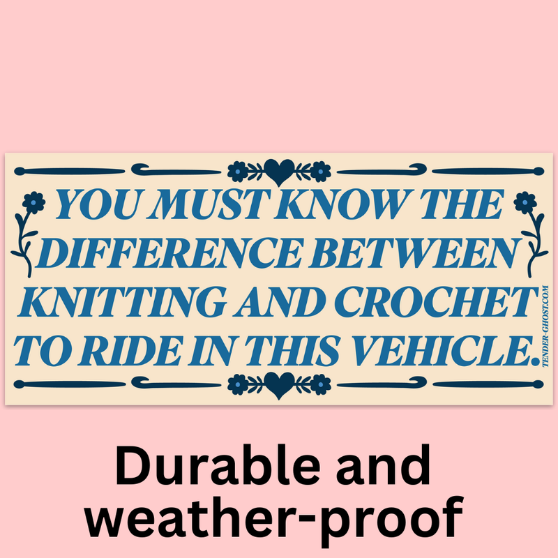Sign with text "You must know the difference between knitting and crochet to ride in this vehicle" on a pink background