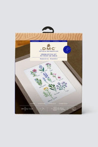 Packaging of cross stitch kit with various herbs against a white background