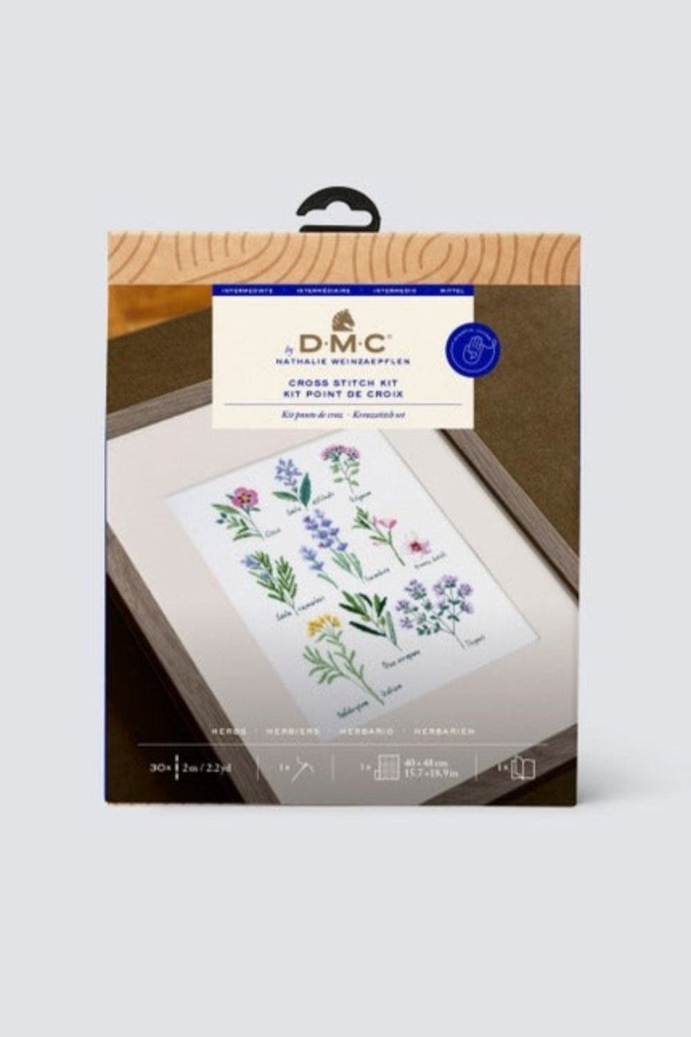 Packaging of cross stitch kit with various herbs against a white background
