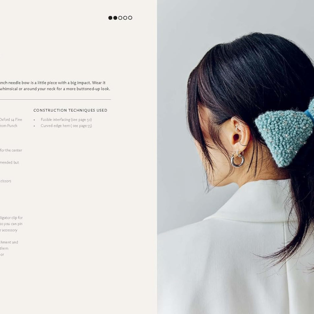 Woman with a blue bow in her hair against a light gray background