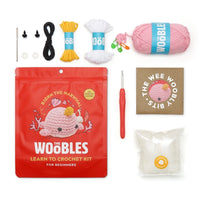 Contents of the kit including the pouch, crochet hook, stuffing, yarn, stitch markers, needle, eyes and instructions.