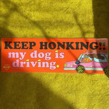 Bumper sticker that reads Keep Honking!! my dog is driving